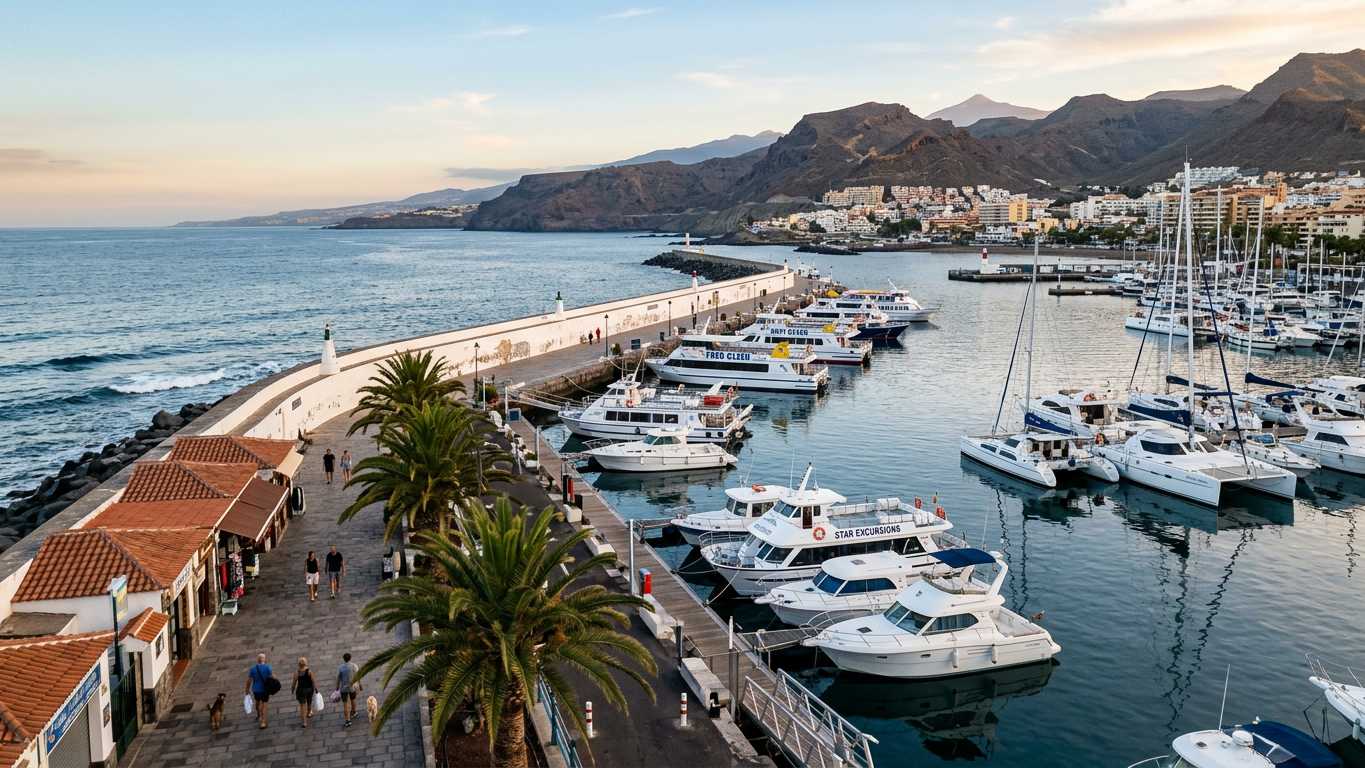 Los Cristianos harbour with boats docked and palm-lined promenade
