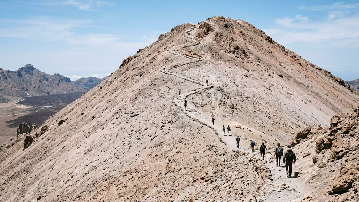 Rocky trail zigzagging up steep volcanic cone of Teide summit